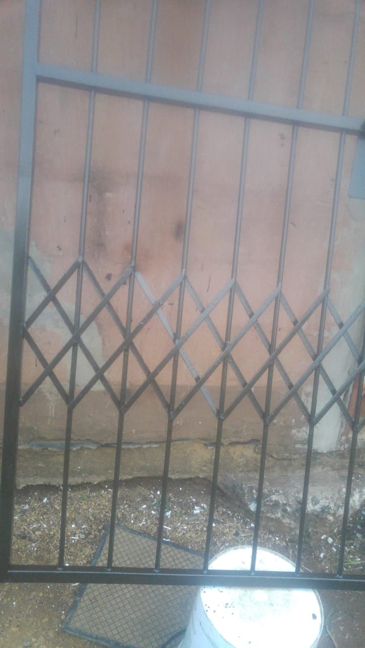 Steel security gate panel with diamond lattice pattern